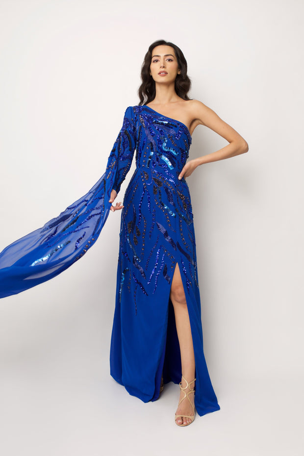 “embroidered cobalt blue one shoulder maxi dress with a draped georgette train”.