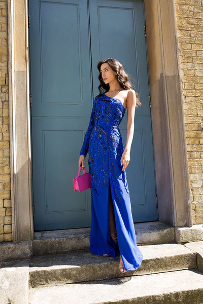 “embroidered cobalt blue one shoulder maxi dress with a draped georgette train”.